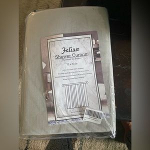 Grey cloth shower curtain with black stitching at the bottom. Bathroom decor.